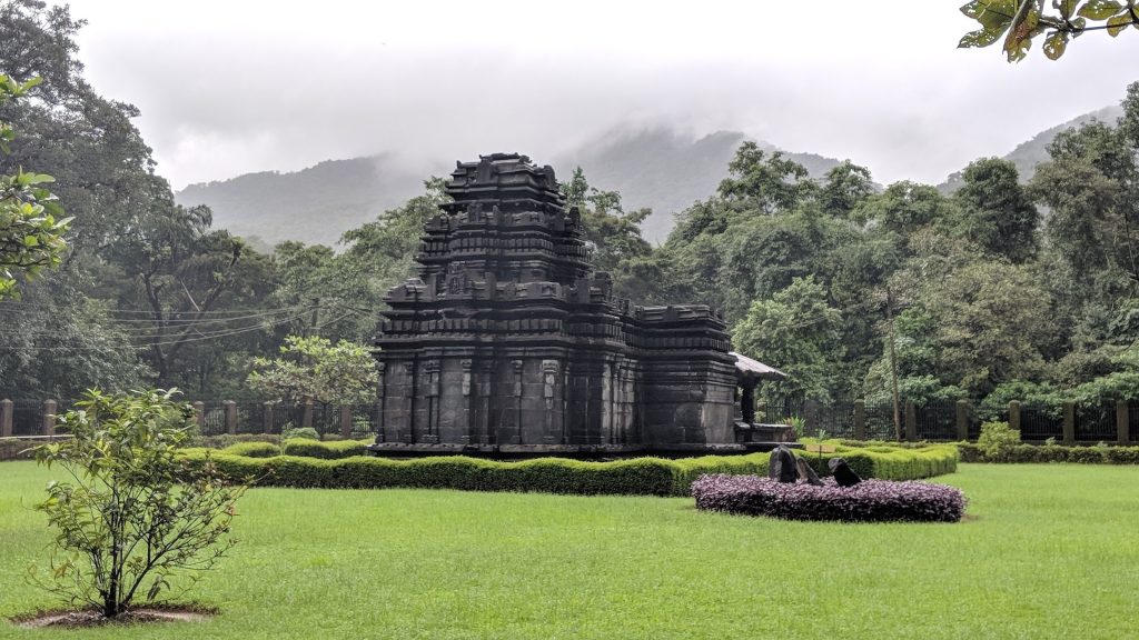 Ancient Tambdi Surla Temple surrounded by lush greenery in Goa